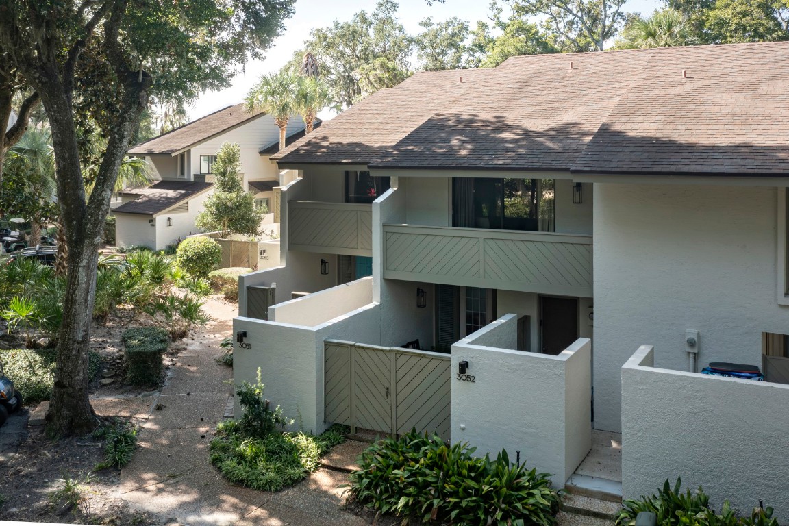 3052 Sea Marsh Road Fernandina Beach, FL 32034 - Photo 2 of 41 a view of a white house next to a yard
