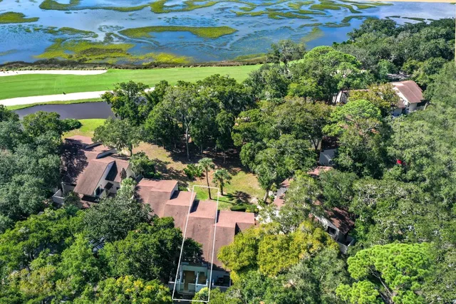 an aerial view of house with yard and mountain view in back