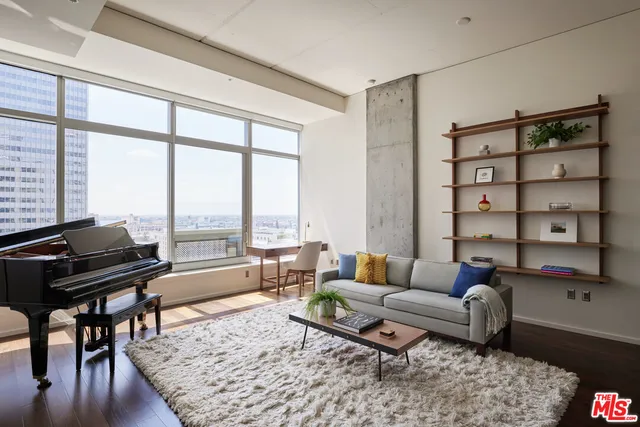 a living room with furniture and a floor to ceiling window