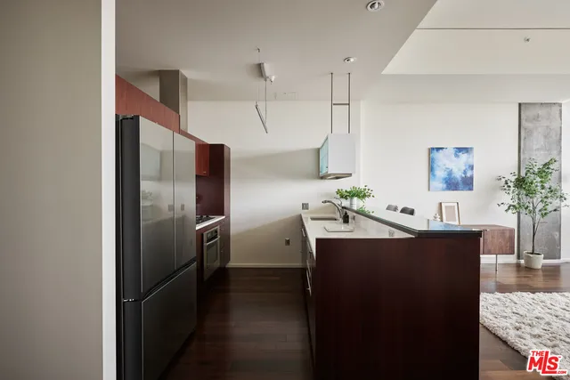 a kitchen with stainless steel appliances a refrigerator and a counter space