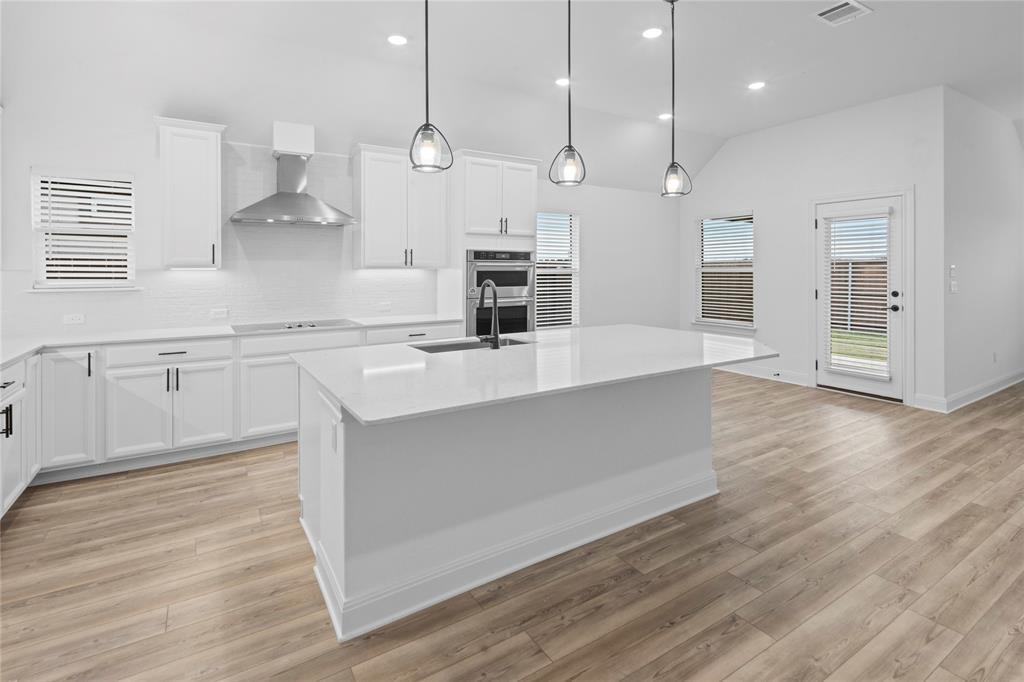 181 Slenderleaf Drive Marble Falls, TX 78654 - Photo 15 of 29 a large kitchen with granite countertop a large counter top a sink stainless steel appliances and cabinets