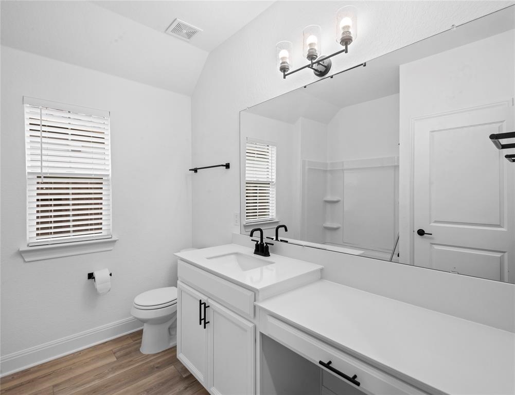 181 Slenderleaf Drive Marble Falls, TX 78654 - Photo 19 of 29 a bathroom with a sink a toilet and a mirror