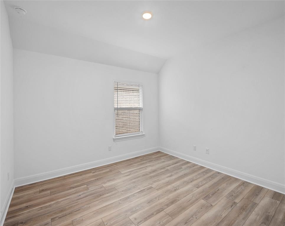 181 Slenderleaf Drive Marble Falls, TX 78654 - Photo 21 of 29 an empty room with wooden floor and windows