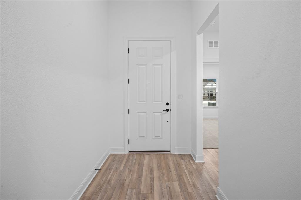181 Slenderleaf Drive Marble Falls, TX 78654 - Photo 22 of 29 a view of an empty room with wooden floor