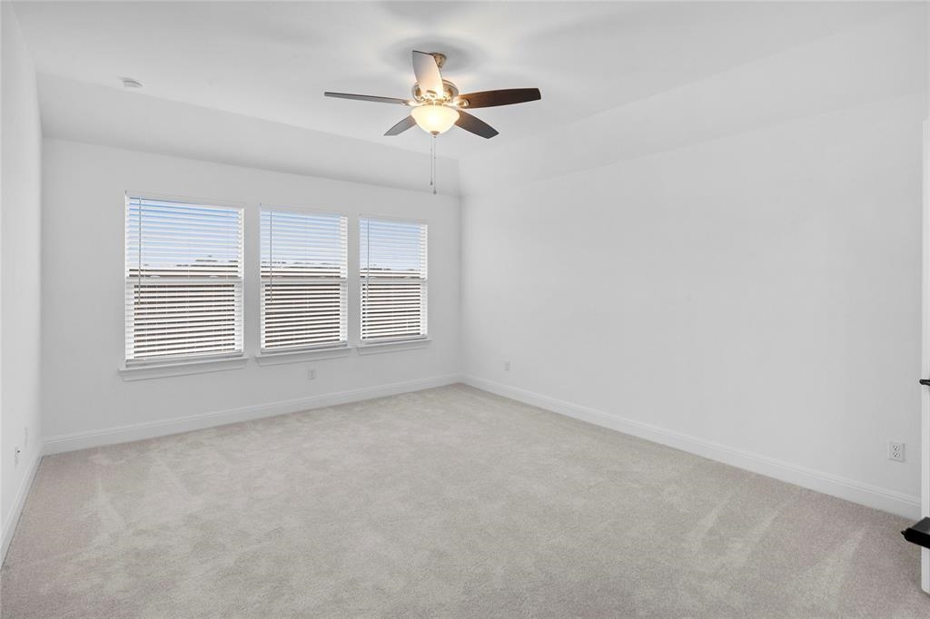 181 Slenderleaf Drive Marble Falls, TX 78654 - Photo 6 of 29 an empty room with a ceiling fan and window