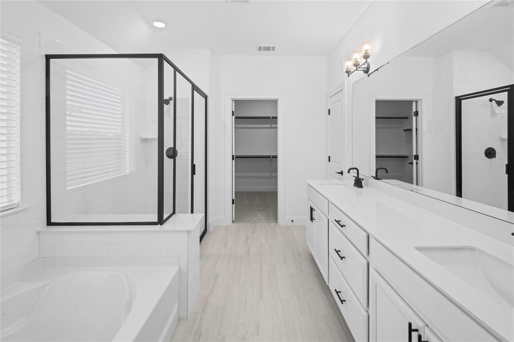 181 Slenderleaf Drive Marble Falls, TX 78654 - Photo 7 of 29 a spacious bathroom with a double vanity sink and mirror