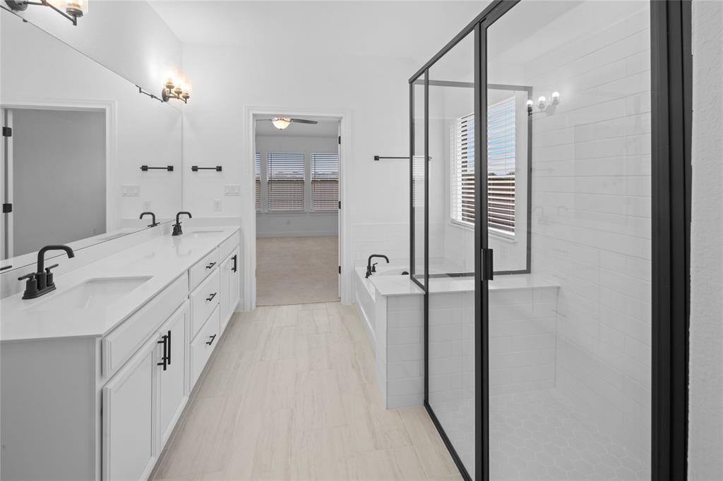 181 Slenderleaf Drive Marble Falls, TX 78654 - Photo 9 of 29 a bathroom with a double vanity sink a mirror and shower