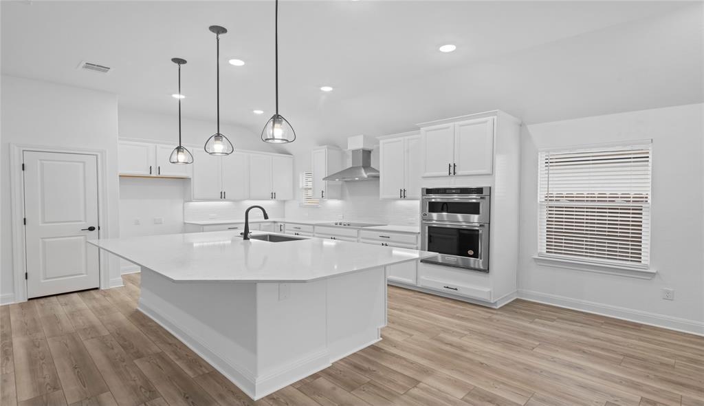 181 Slenderleaf Drive Marble Falls, TX 78654 - Photo 10 of 29 a large white kitchen with stainless steel appliances