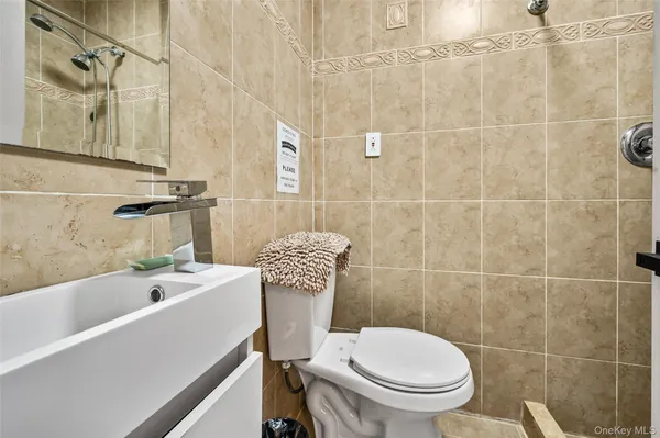 a white toilet sitting next to a bathtub