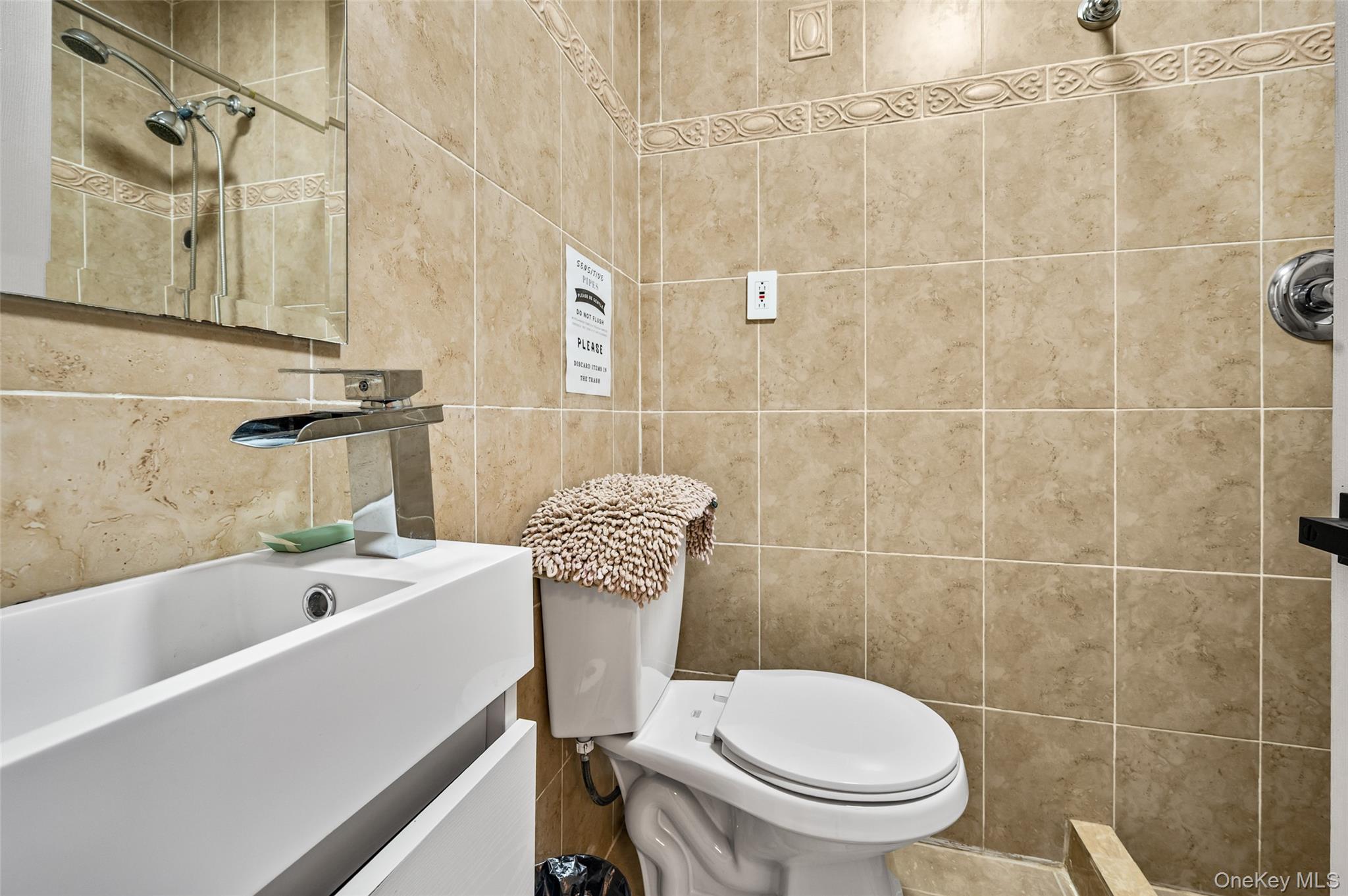1016 Westwood Road Woodmere, NY 11598 - Photo 17 of 23 Full bathroom featuring a tile shower, vanity, and tile walls