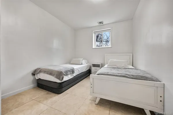 a bedroom with a bed and a lamp on table