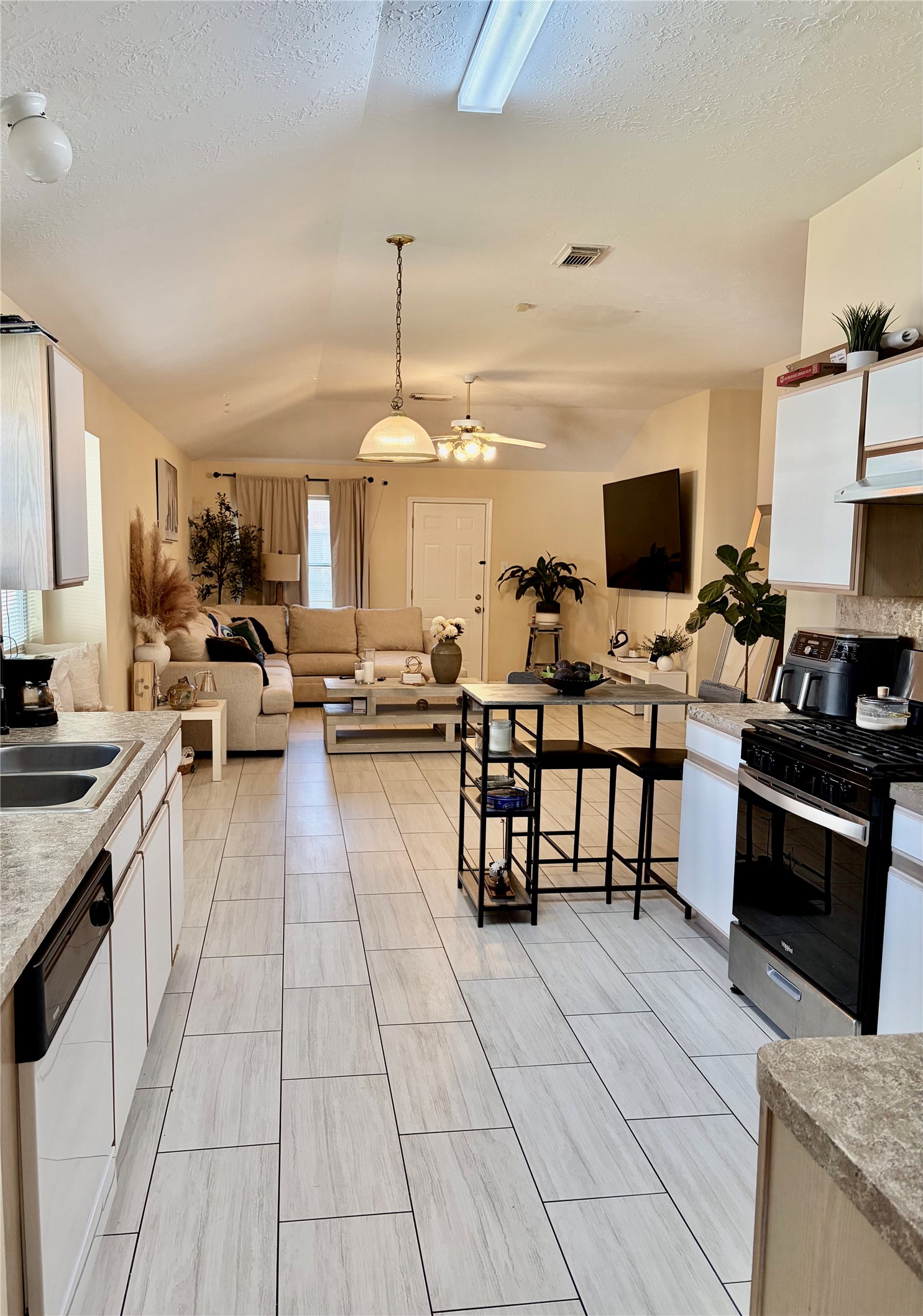 5329 Tallowpine Terrace Katy, TX 77493 - Photo 8 of 21 a living room with stainless steel appliances kitchen island granite countertop a sink and a stove