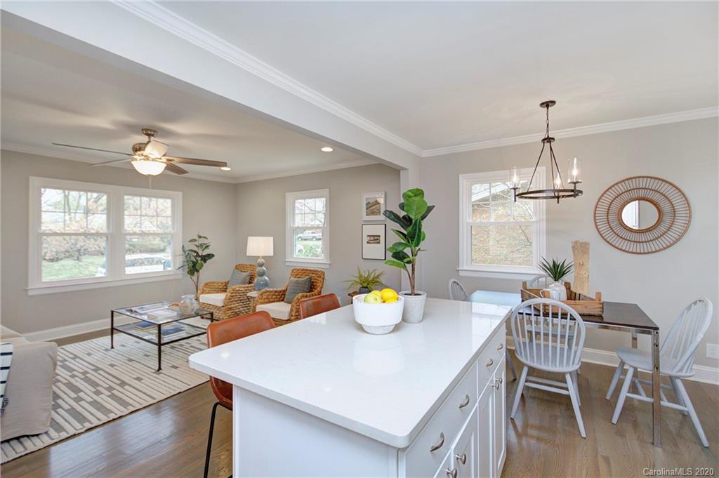 3908 Farmview Road Charlotte, NC 28205 - Photo 12 of 25 a view of a dining room with furniture and wooden floor