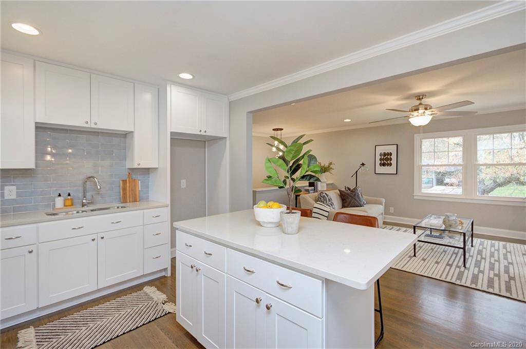 3908 Farmview Road Charlotte, NC 28205 - Photo 13 of 25 a kitchen with stainless steel appliances kitchen island granite countertop a sink a stove and cabinets