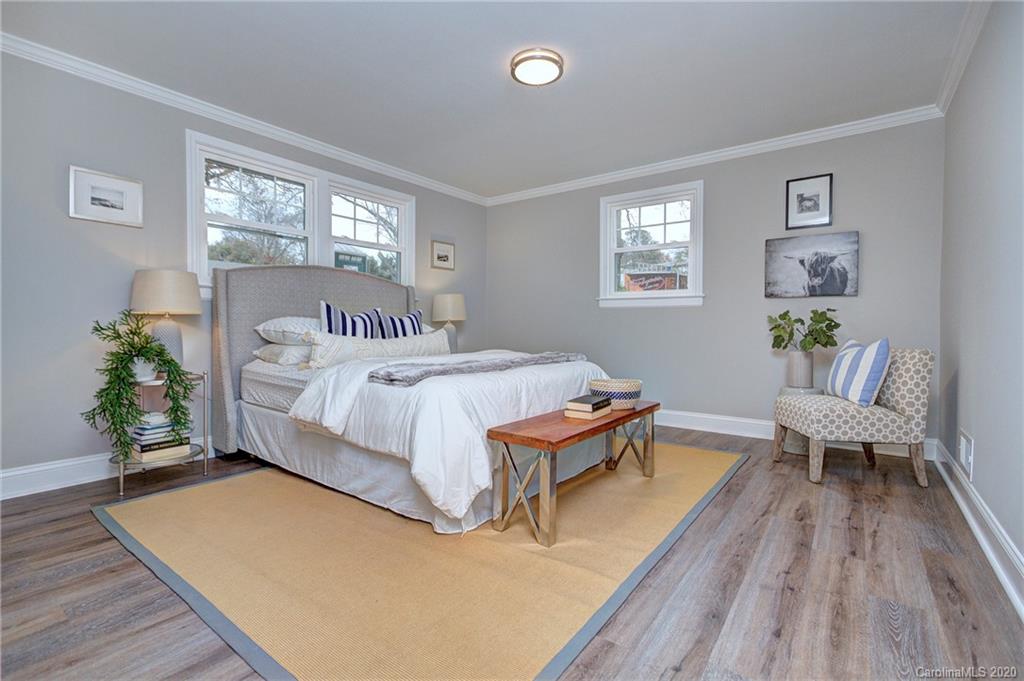 3908 Farmview Road Charlotte, NC 28205 - Photo 14 of 25 a bedroom with a bed and wooden floor