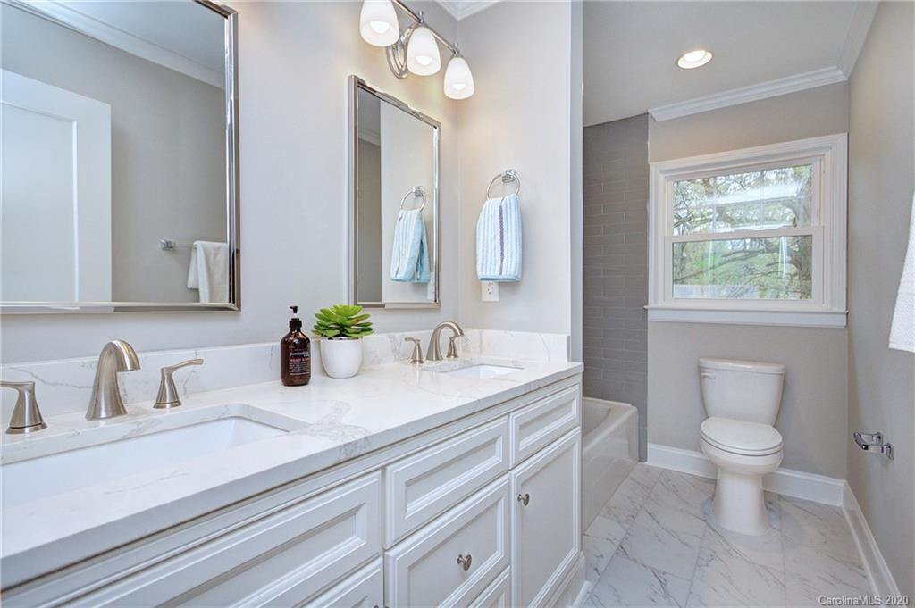 3908 Farmview Road Charlotte, NC 28205 - Photo 15 of 25 a bathroom with a toilet a sink and mirror