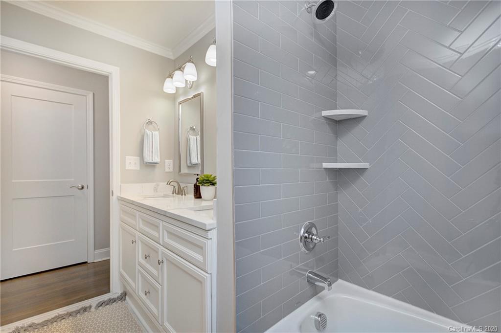 3908 Farmview Road Charlotte, NC 28205 - Photo 16 of 25 a bathroom with a bathtub a sink a toilet a and mirror