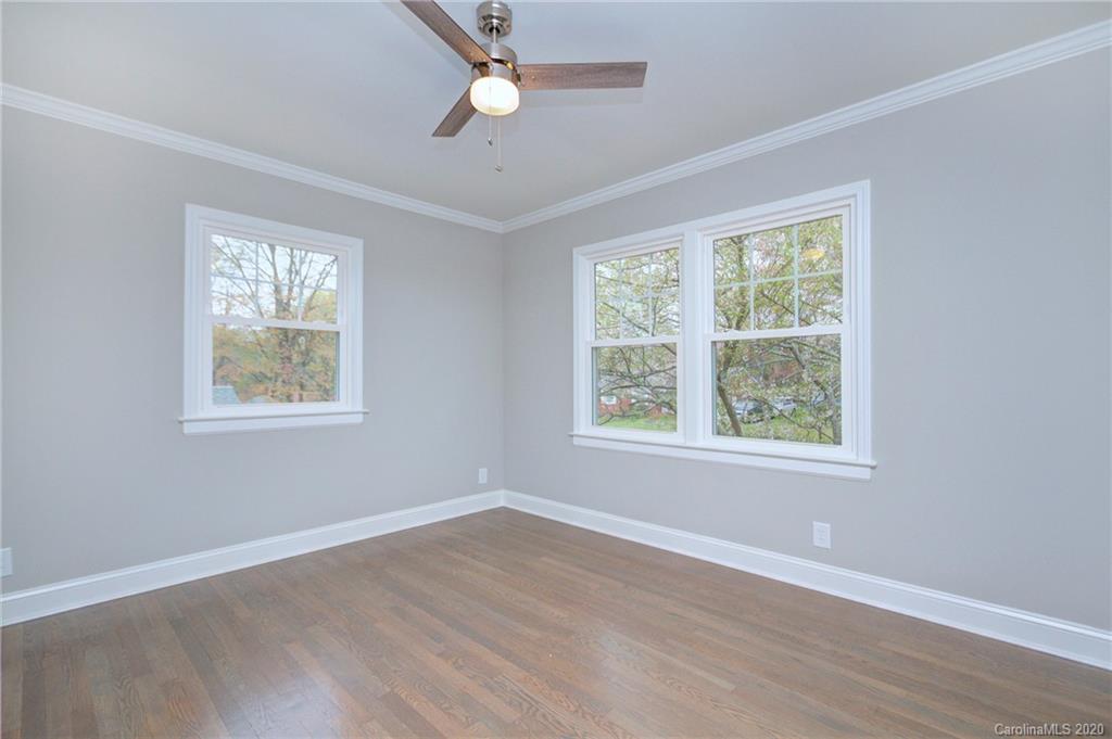 3908 Farmview Road Charlotte, NC 28205 - Photo 18 of 25 a view of an empty room with wooden floor and a window