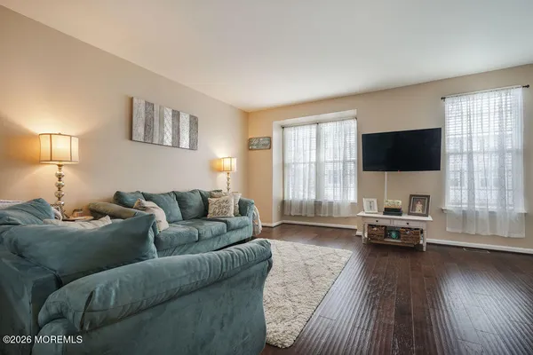 a living room with furniture and large windows