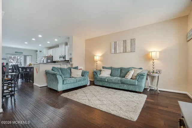 a kitchen with a dining table chairs refrigerator and cabinets