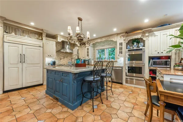 a kitchen with granite countertop cabinets and chairs