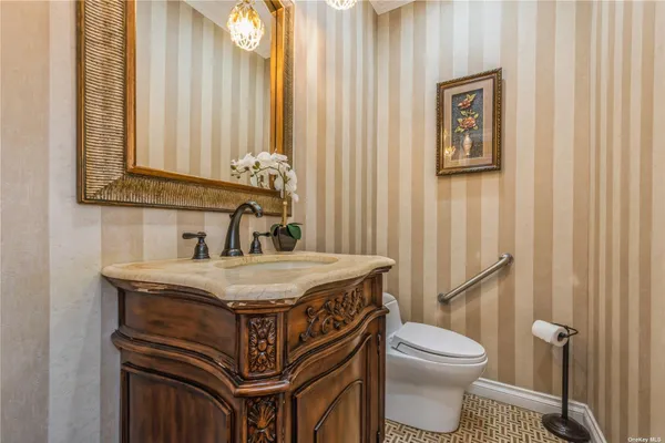 a bathroom with a sink a toilet and mirror