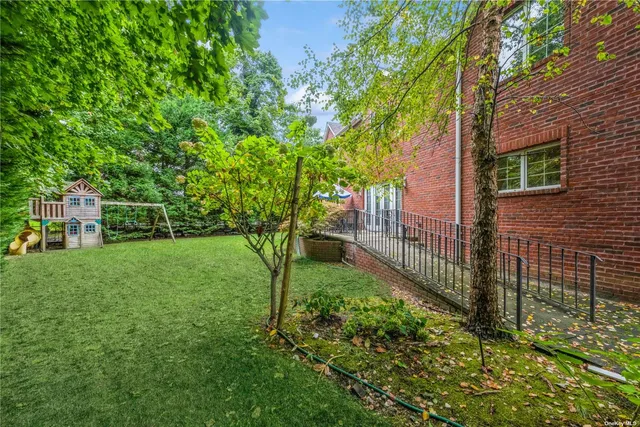 a view of a backyard with large trees