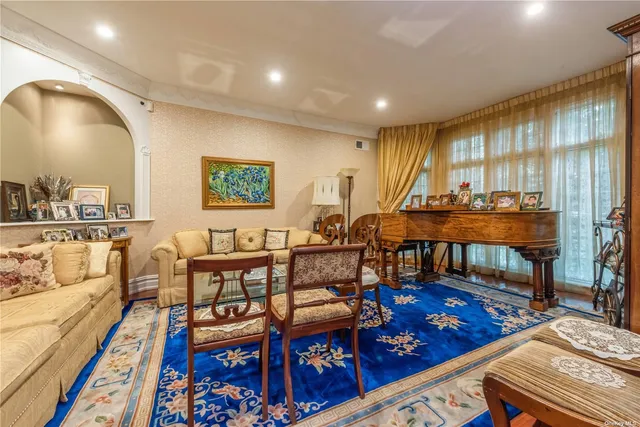 a living room with furniture a rug and a table