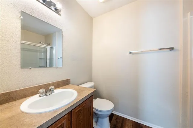 a bathroom with a sink toilet and a mirror