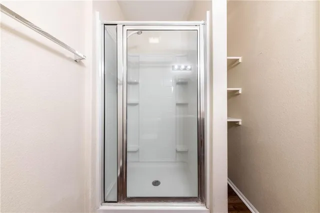 a bathroom with a glass shower door