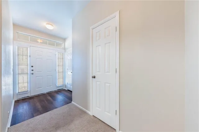 an empty room with wooden floor and closet