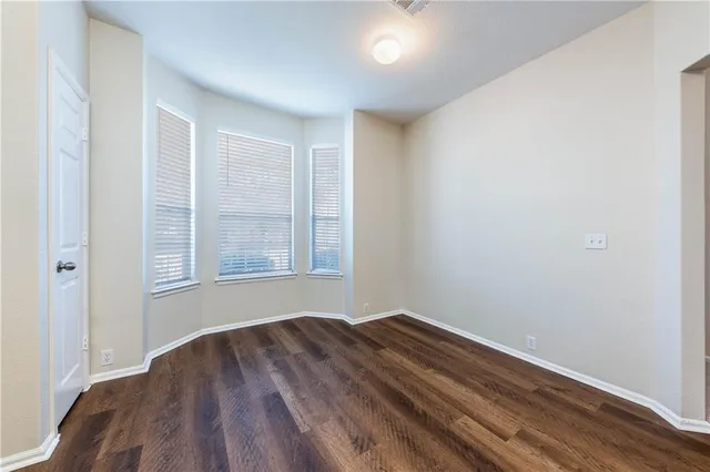 a view of room with window and hardwood floor