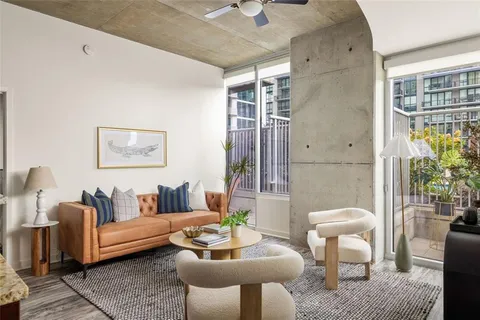 a living room with furniture and a potted plant