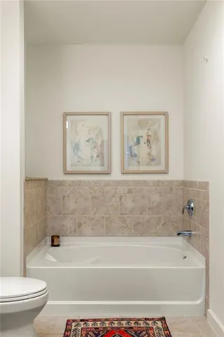 a bathroom with a bathtub and a toilet