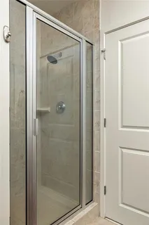 a bathroom with a glass shower door