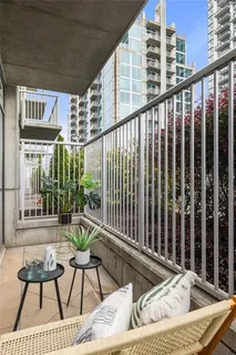 a balcony with table and chairs