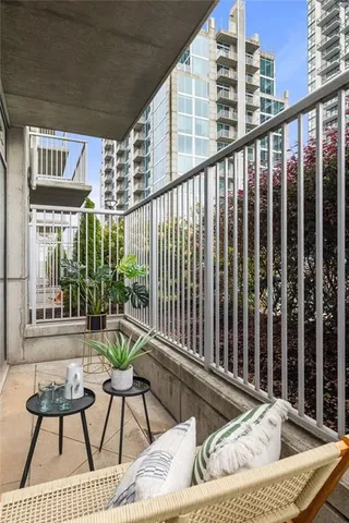 a balcony with table and chairs
