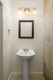 a bathroom with a sink a mirror and a toilet