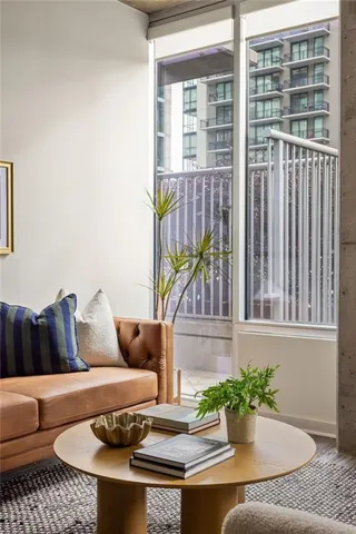 a living room with furniture and a potted plant