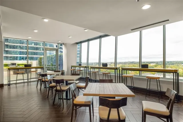 a view of a dining room with furniture window and wooden floor