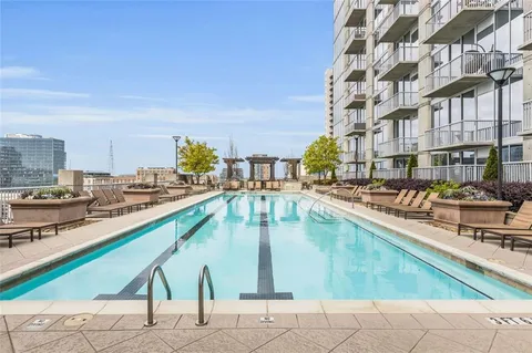 a view of swimming pool with outdoor seating