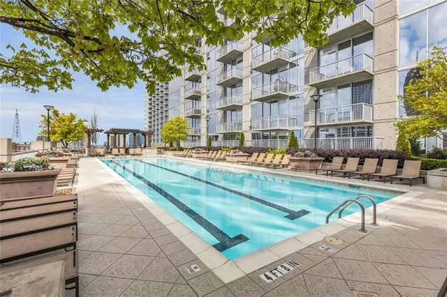 a swimming pool view with outdoor seating