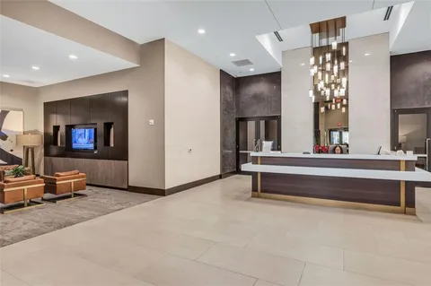 a living room with furniture and a large mirror