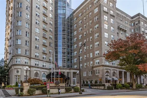 a view of staircase with white walls and cabinet
