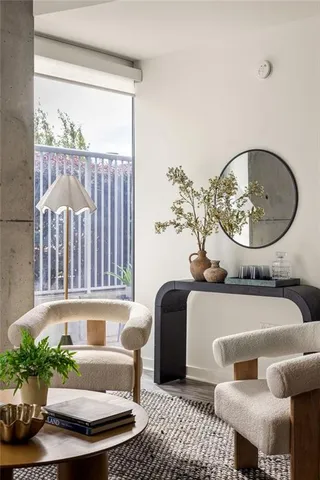a living room with furniture flowerpot and a window