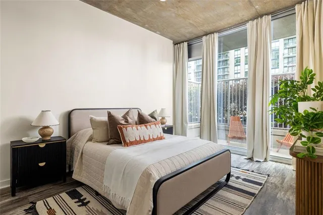 a bedroom with double bed and a potted plant