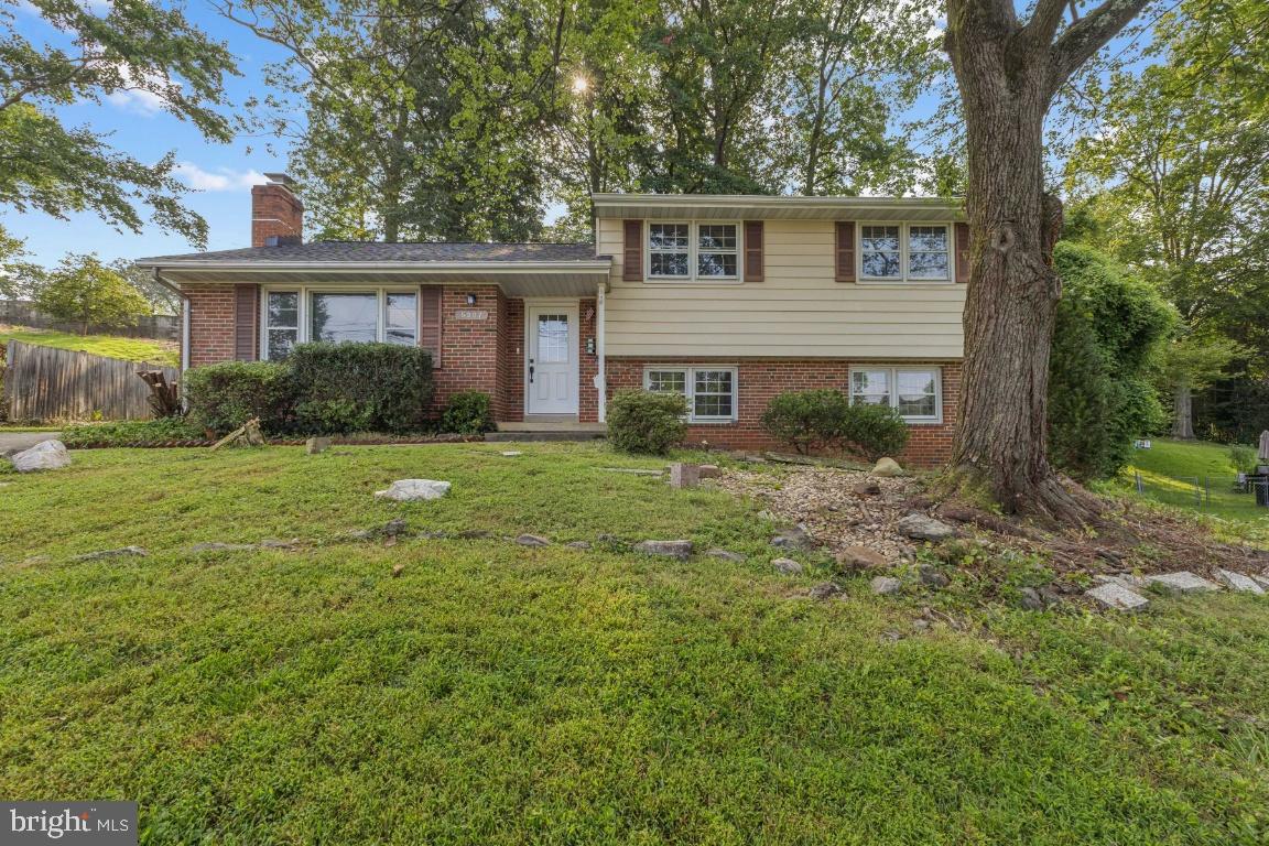 Charming split-level home in lush surroundings.