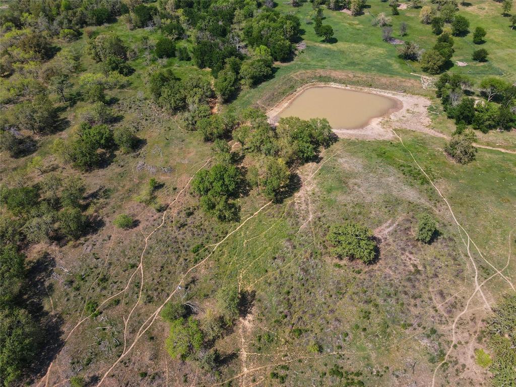 Lot 47 Paradise Oaks Ranch Perrin, TX 76487 - Photo 2 of 8 Aerial view of property and surrounding area with a large body of water and rural landscape
