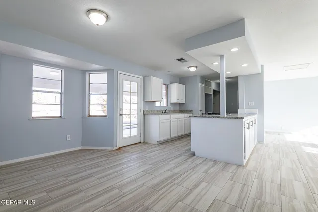 a view of kitchen with wooden floor and electronic appliances