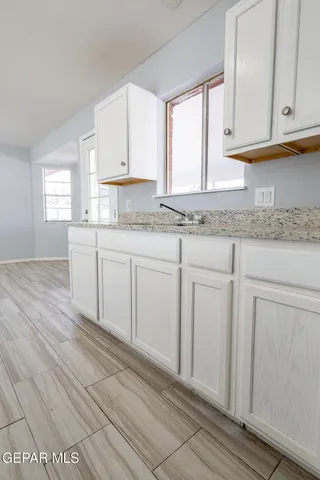 a kitchen with granite countertop a oven and a sink